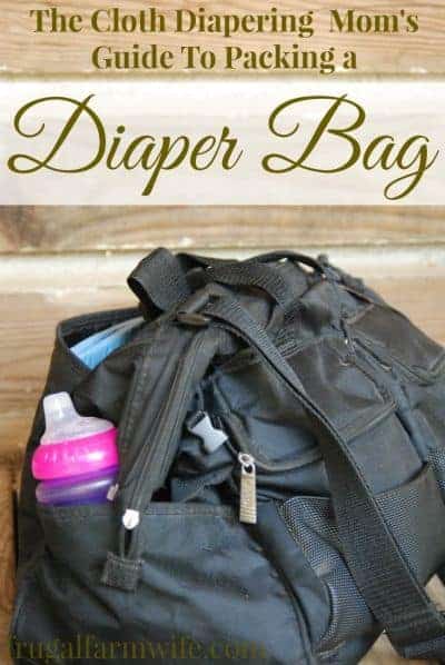Photo shows a diaper bag with text that reads "The Cloth Diapering Mom's Guide to Packing a Diaper Bag"