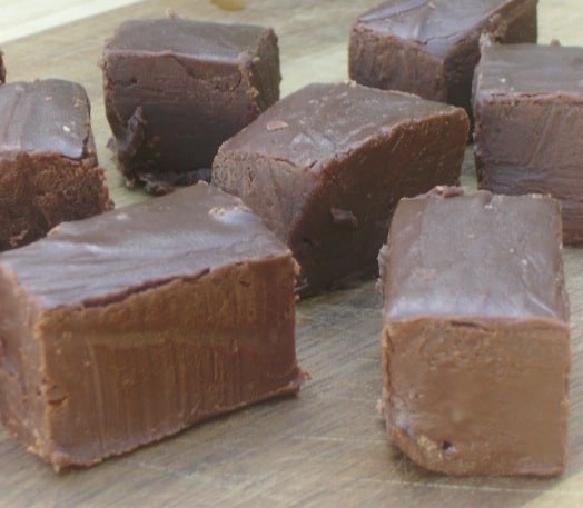 Photo shows several pieces of homemade fudge on a table