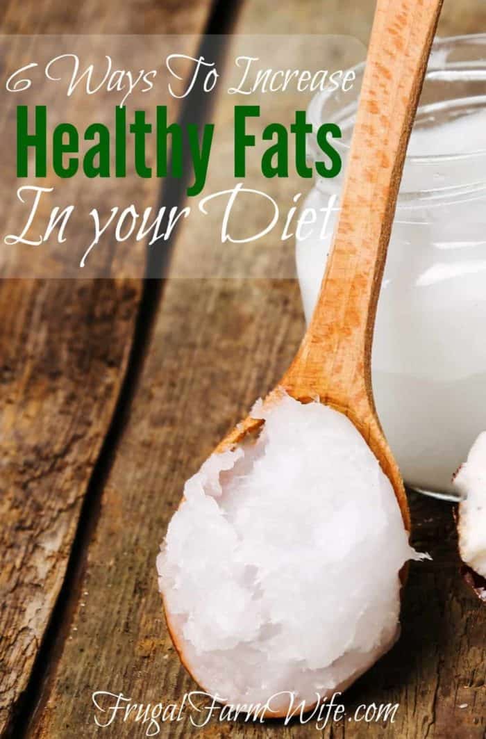 Image depicts coconut oil on a wooden spoon with the text "6 Ways to Increase Healthy Fats in Your Diet"