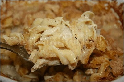 A forkful of old fashioned chicken casserole with toasted bread crumbs