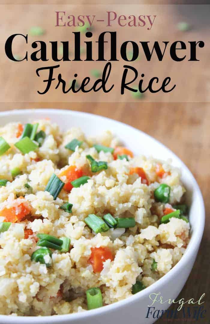 Image shows a close up of a large bowl of fried rice, with vegetables and scallions mixed in. Text above reads "Easy Peasy Cauliflower Fried Rice"