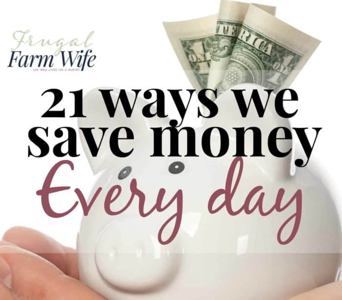 Image shows a hand holding a small piggy bank with a dollar bill sticking out of it, with text overlay reading "21 ways we save money every day"