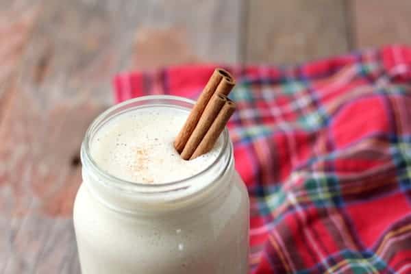 Photo shows a jar of eggnog with cinnamon sticks in it