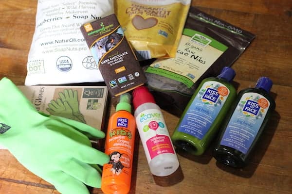 Photo shows a number of products from my iHerb box displayed on a table, including bottles of products and a pair of green rubber gloves. 