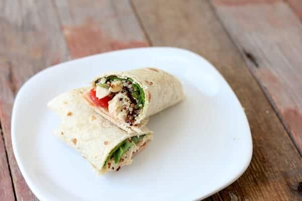 Image shows a taco cut in half on a white plate