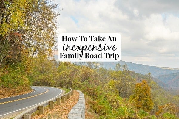 Image shows a winding road along the side of some mountains in the fall, with text that reads "How to Take an Inexpensive Family Road Trip"