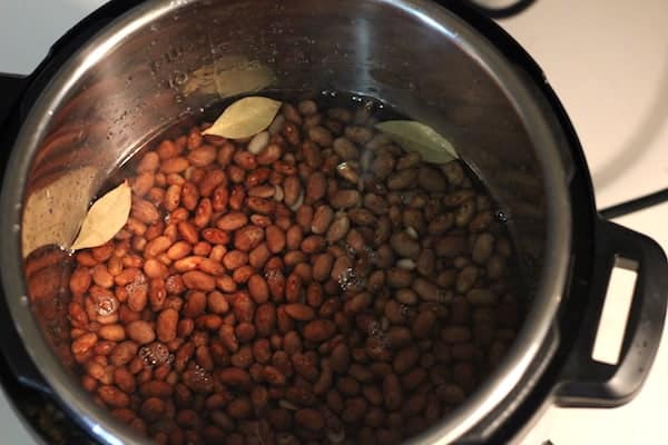 Image, taken from above, shows the water level over the beans inside an Instant Pot before cooking.