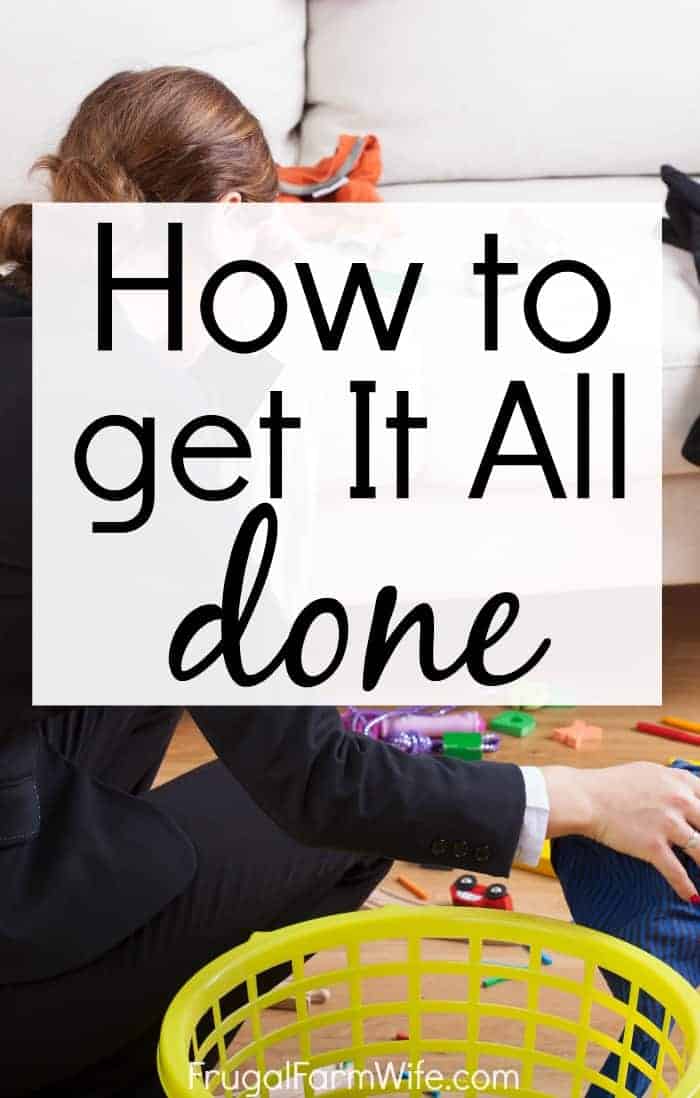 Image shows a woman crouched in a room full of toys and other items scattered on the floor. Text overlay reads "How to Get It All Done"