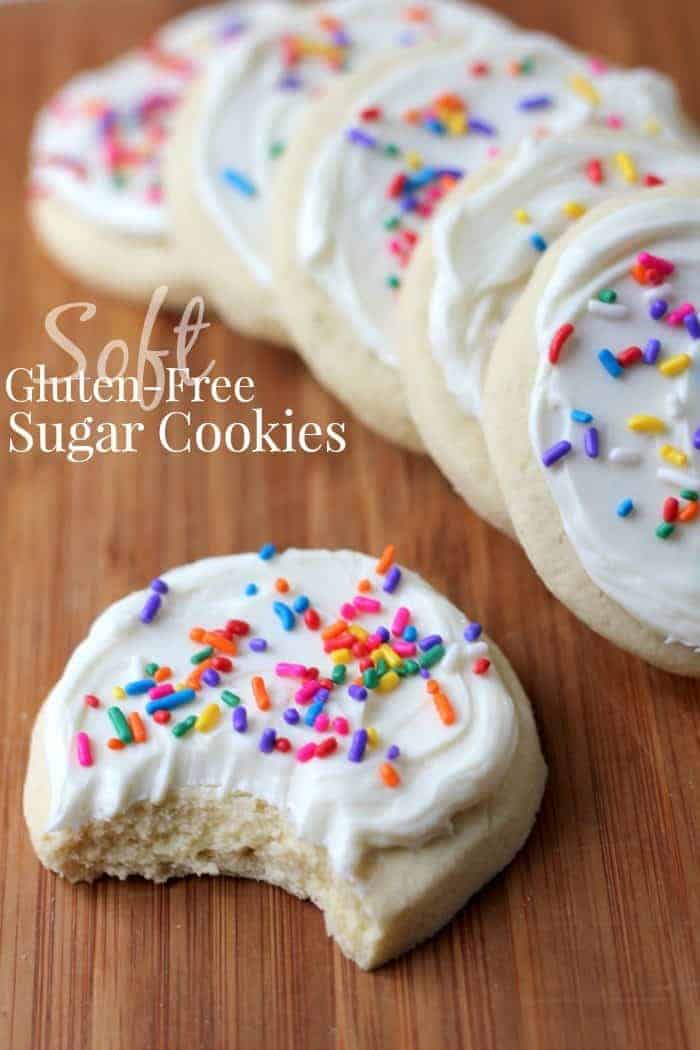 Image shows a pile of gluten-free sugar cookies with white frosting and rainbow sprinkles. Text reads "soft gluten-free sugar cookies"