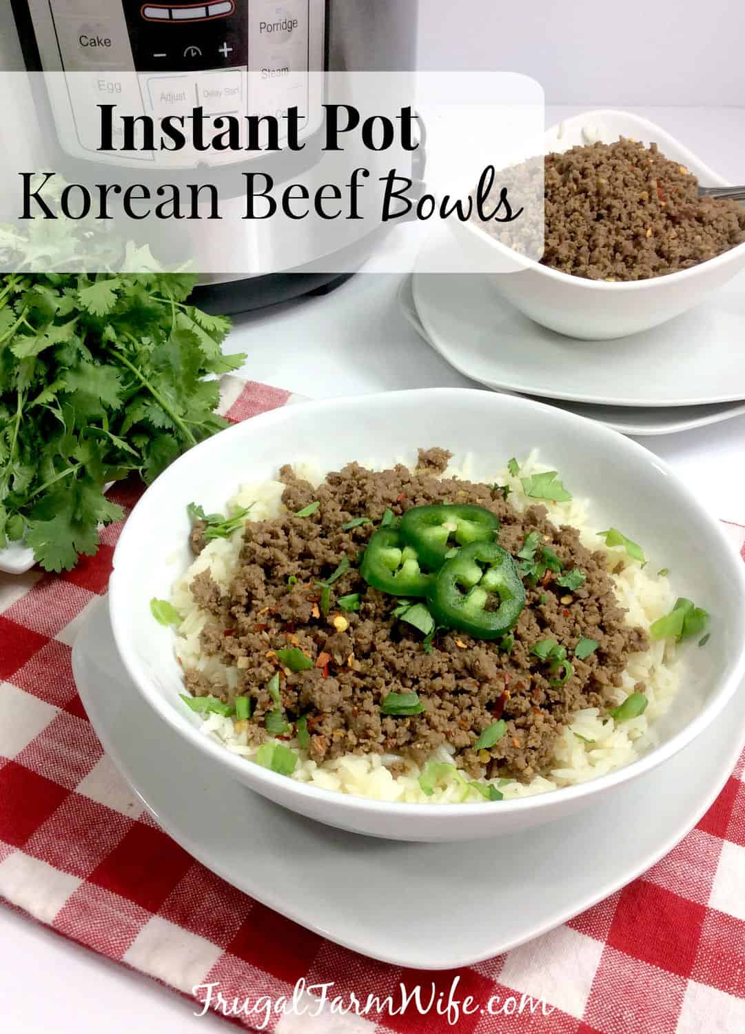 Image shows an Instant Pot in the background with a bowl of Korean Beef next to it. At the forefront of the photo is a completed Korean Beef bowl topped with jalapeno and cilantro. Text overlay reads "Instant Pot Korean Beef Bowls"