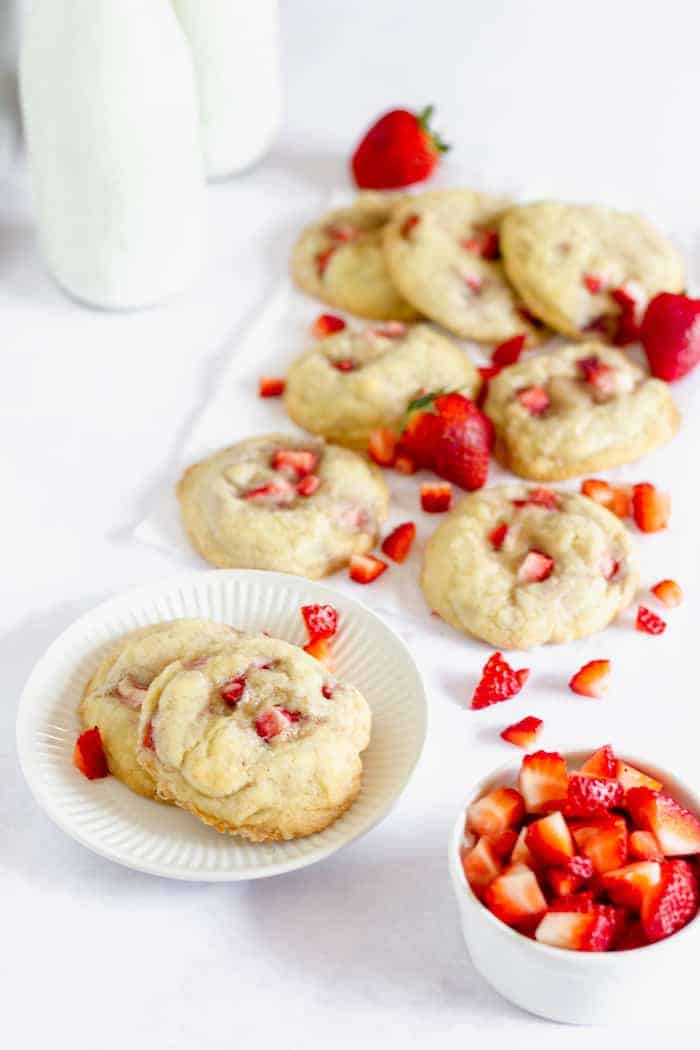 Photo shows a plate full of strawberry cookies on a white table