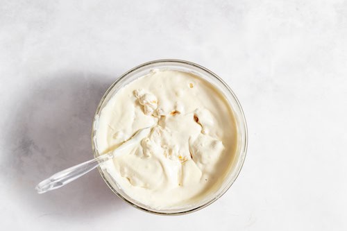 Photo, taken from above, shows all the ingredients fully mixed together for peach cobbler ice cream.