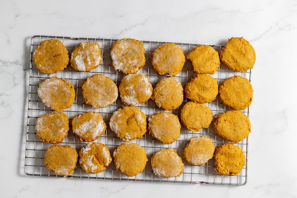 Image shows pumpkin cookies cooling on a cooling rack