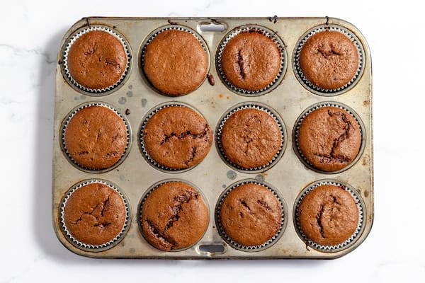 Image, taken from above, shows gluten free chocolate cupcakes, baked, ready to ice