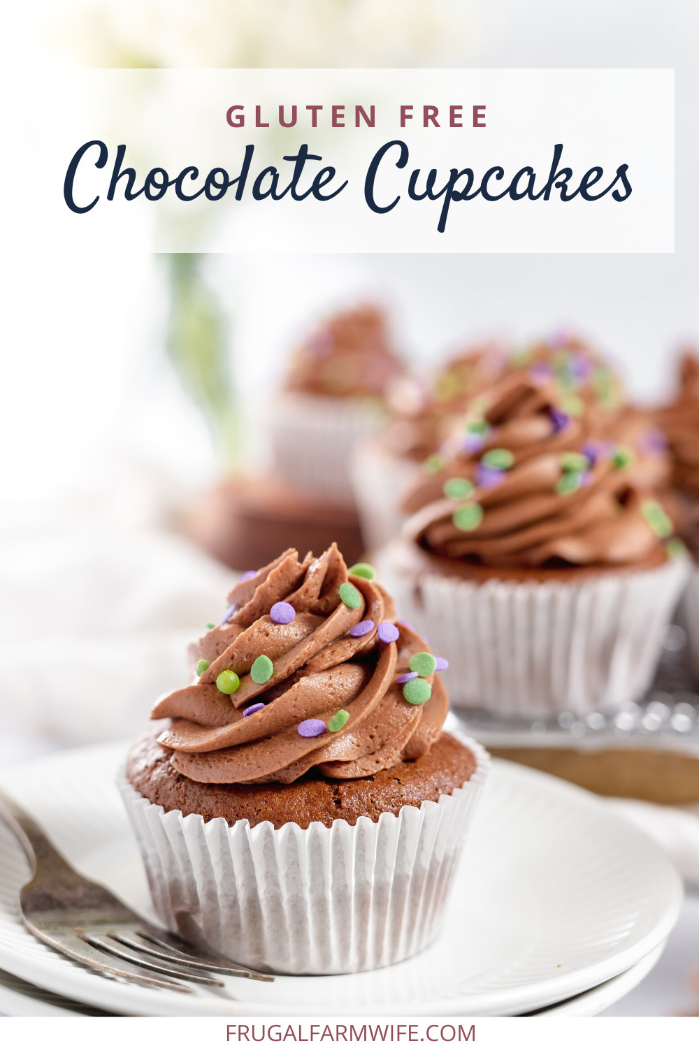 Image shows a gluten free chocolate cupcake, topped with chocolate icing and sprinkles on a white plate in the forefront. In the background are more cupcakes on a cooling rack. Text above reads "Gluten free chocolate cupcakes" 
