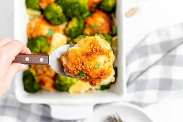 serving chicken from a white baking dish