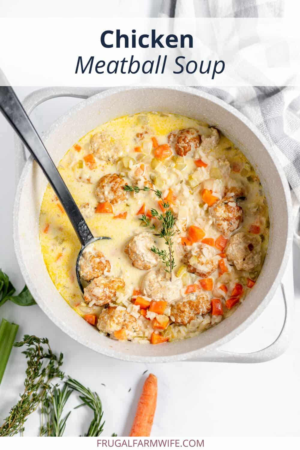 Image, taken from above, shows a pot of creamy chicken meatball soup with a black ladle in it.