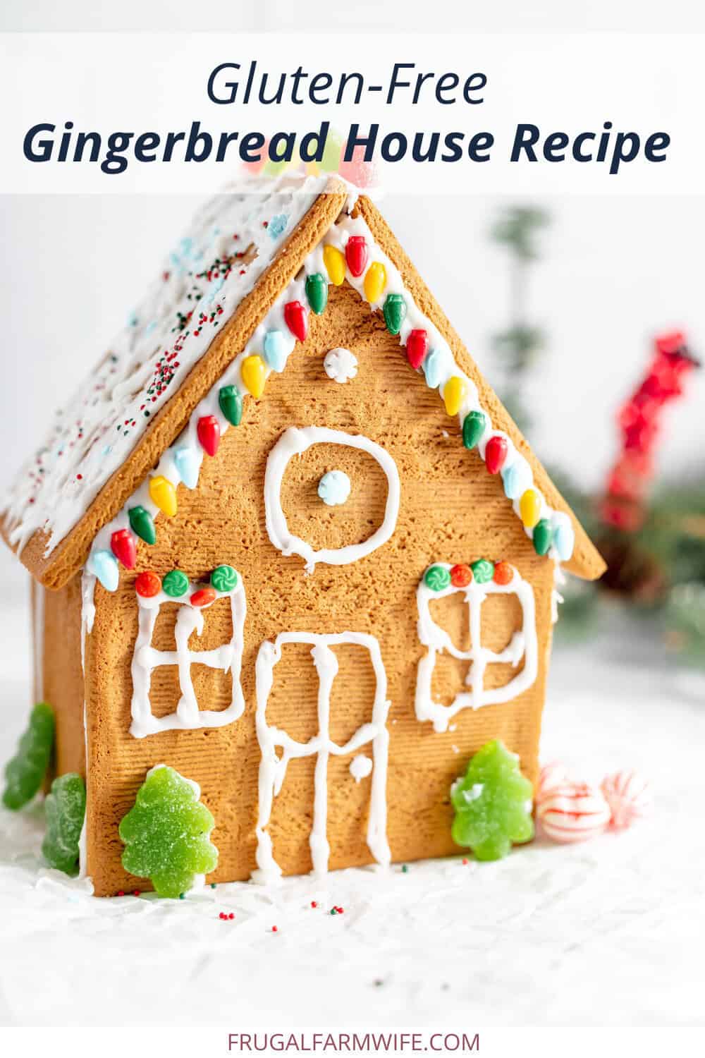 Image shows a small, decorated gluten free gingerbread house on a white table. Text above reads "Gluten-Free Gingerbread House Recipe"