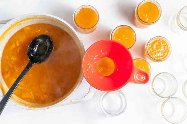 ladling jam into jelly jars for canning