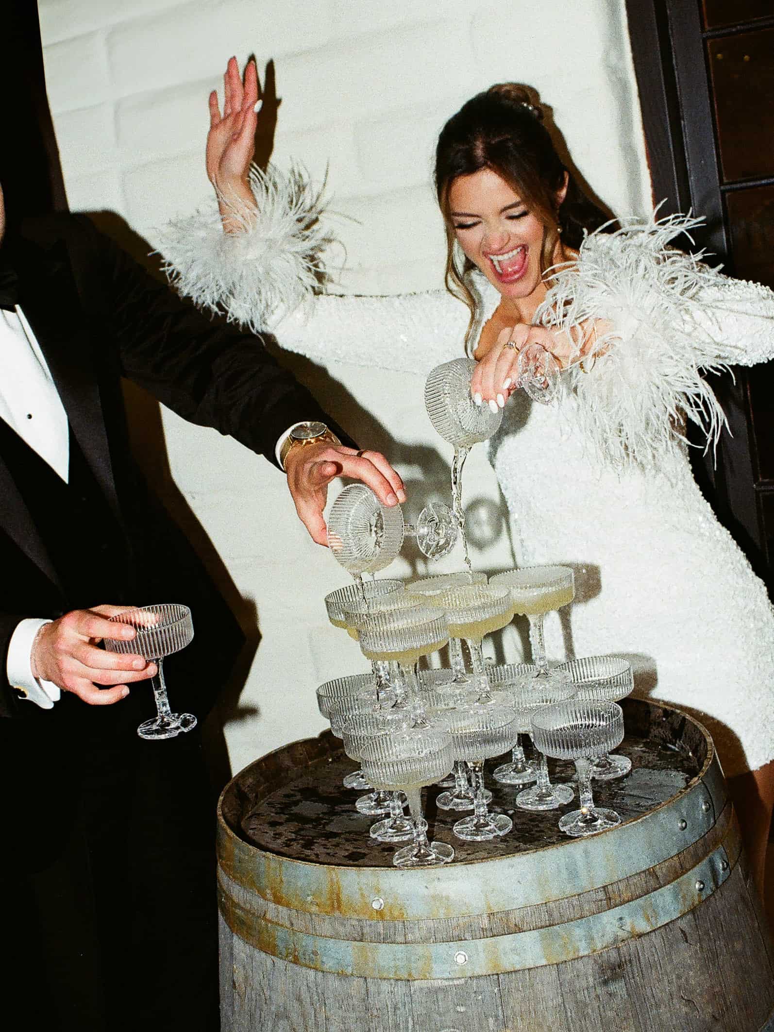 Romantic film wedding photo of a bride and groom champagne tower at Morgan Estate in Temecula
