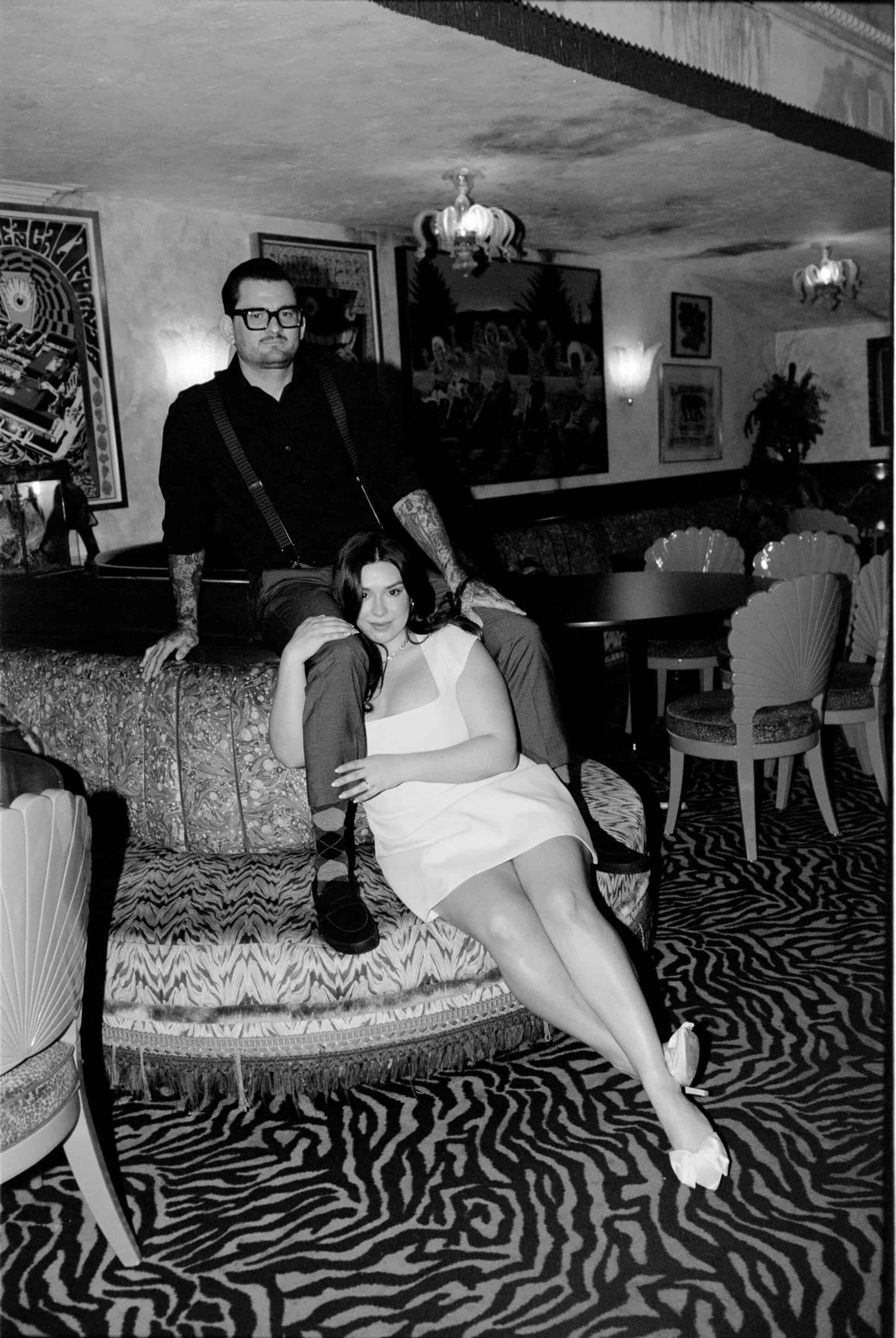 Stylish couple in vintage-inspired interior, black and white photo.