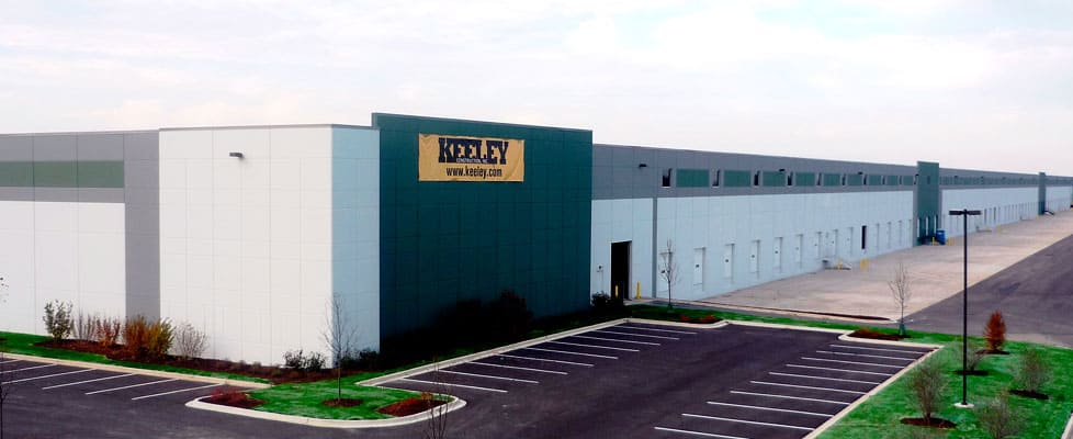 A view of the corner of the new M. Block and Sons’ facility shows the long length and part of the width of the large corporate structure. A yellow banner on the top of the building reads “Keeley Construction, Inc. www.keeley.com.”