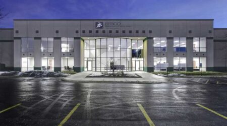 The front of the Wesco building is bright and consists of two stories with large floor to ceiling windows.
