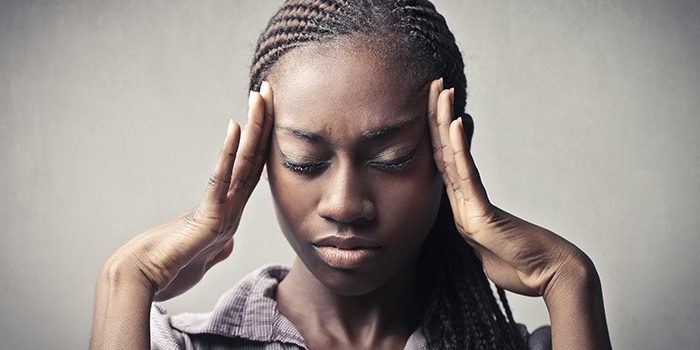 Picture of a lady in pain for blog on recurring UTIs and how to treat them