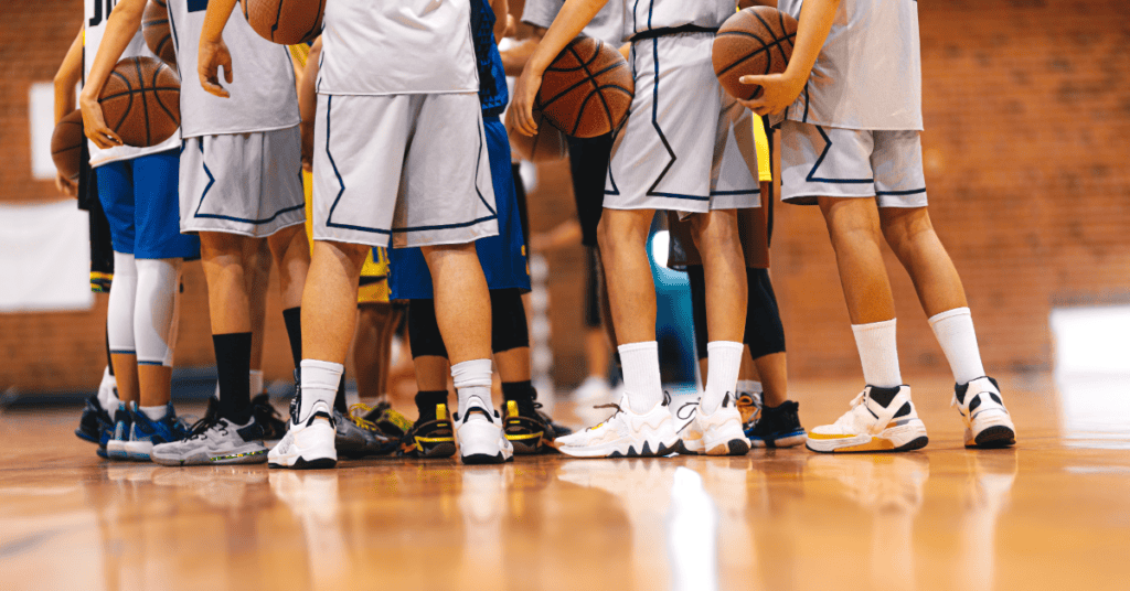 Youth basketball players huddling during a game or practice session.