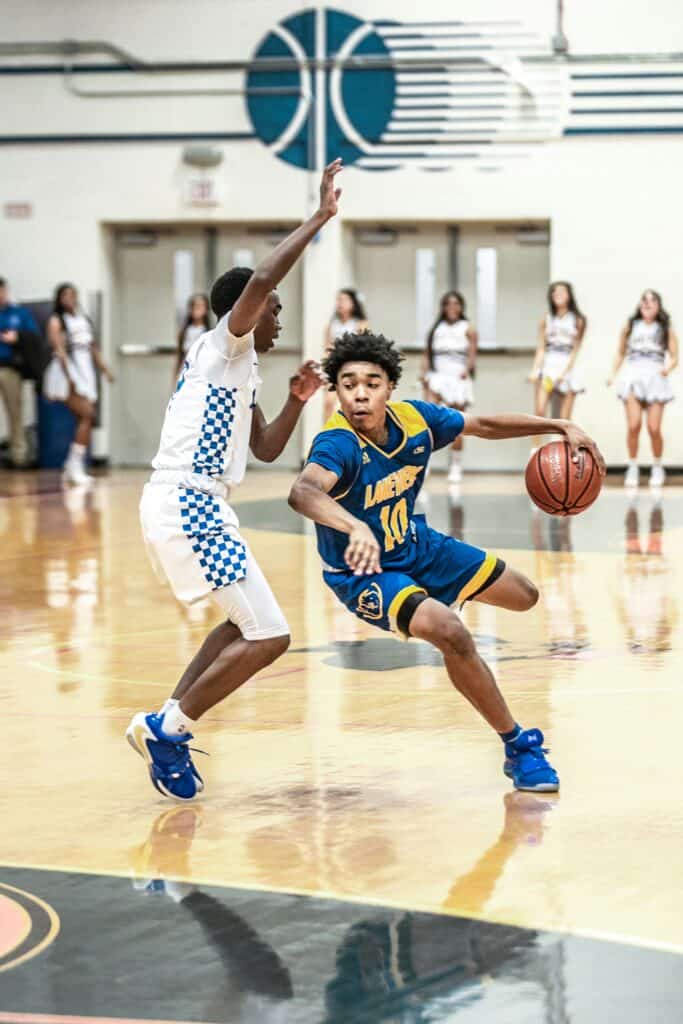 Young basketball players competing fiercely on the court.
