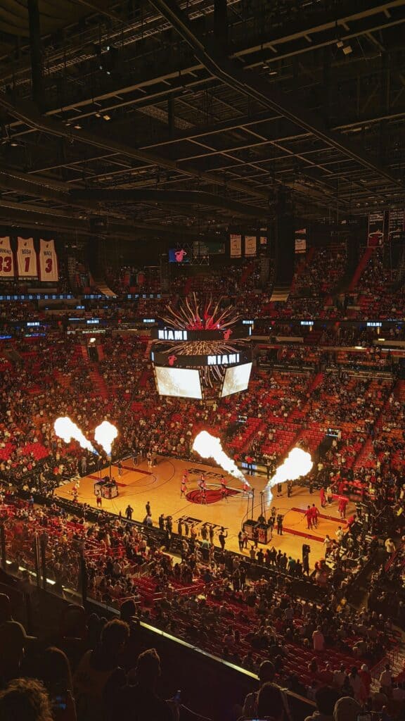 Vibrant Miami Heat game with energetic crowd and fiery court effects.