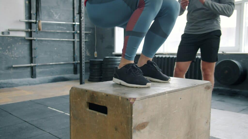 Athlete performing box jump exercise for youth sports training.