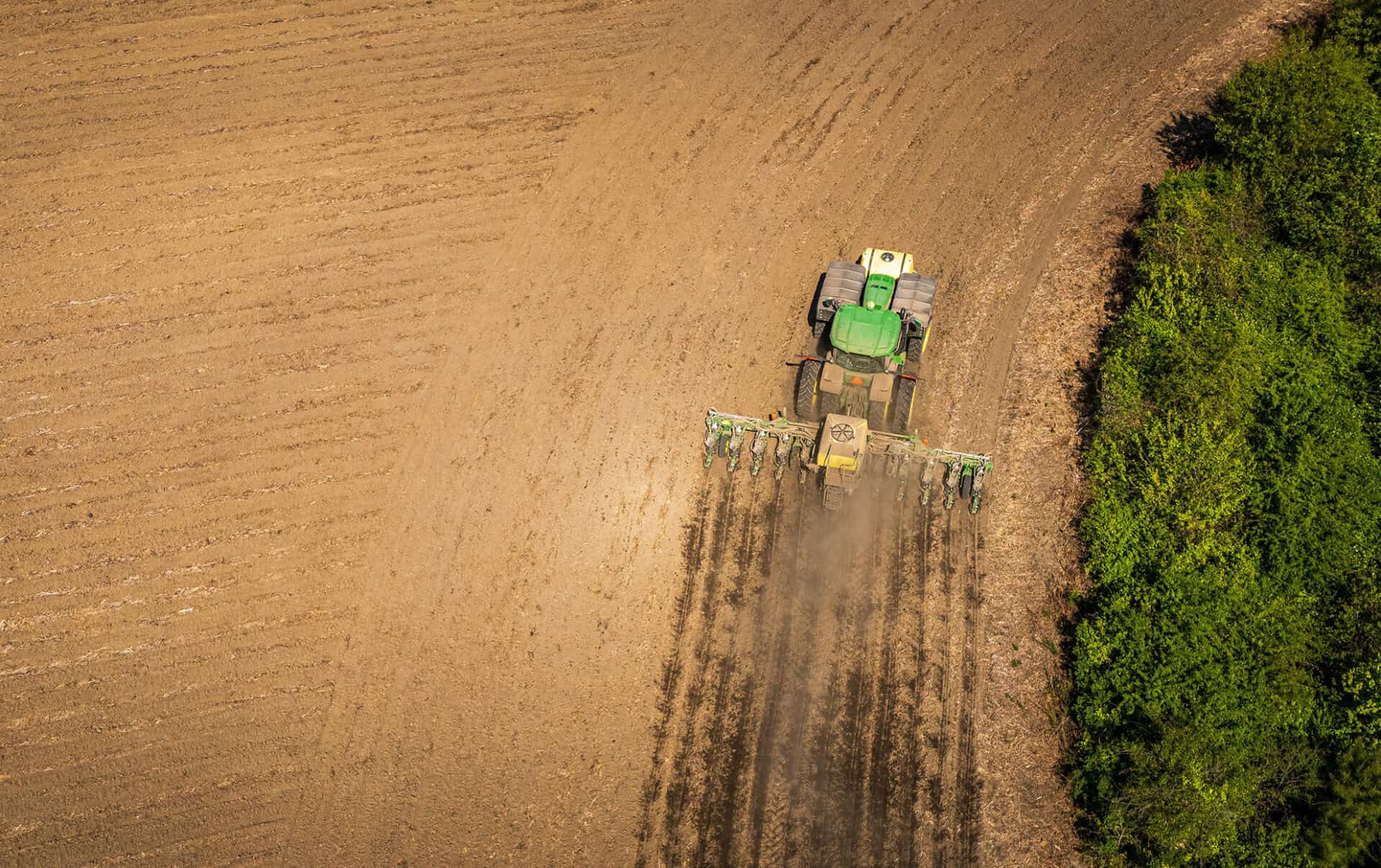 Tractor working on farmland for crop cultivation.