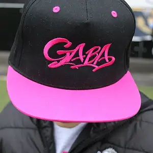 Black and pink GABA branded cap with embroidered logo, stylish headwear for casual wear.
