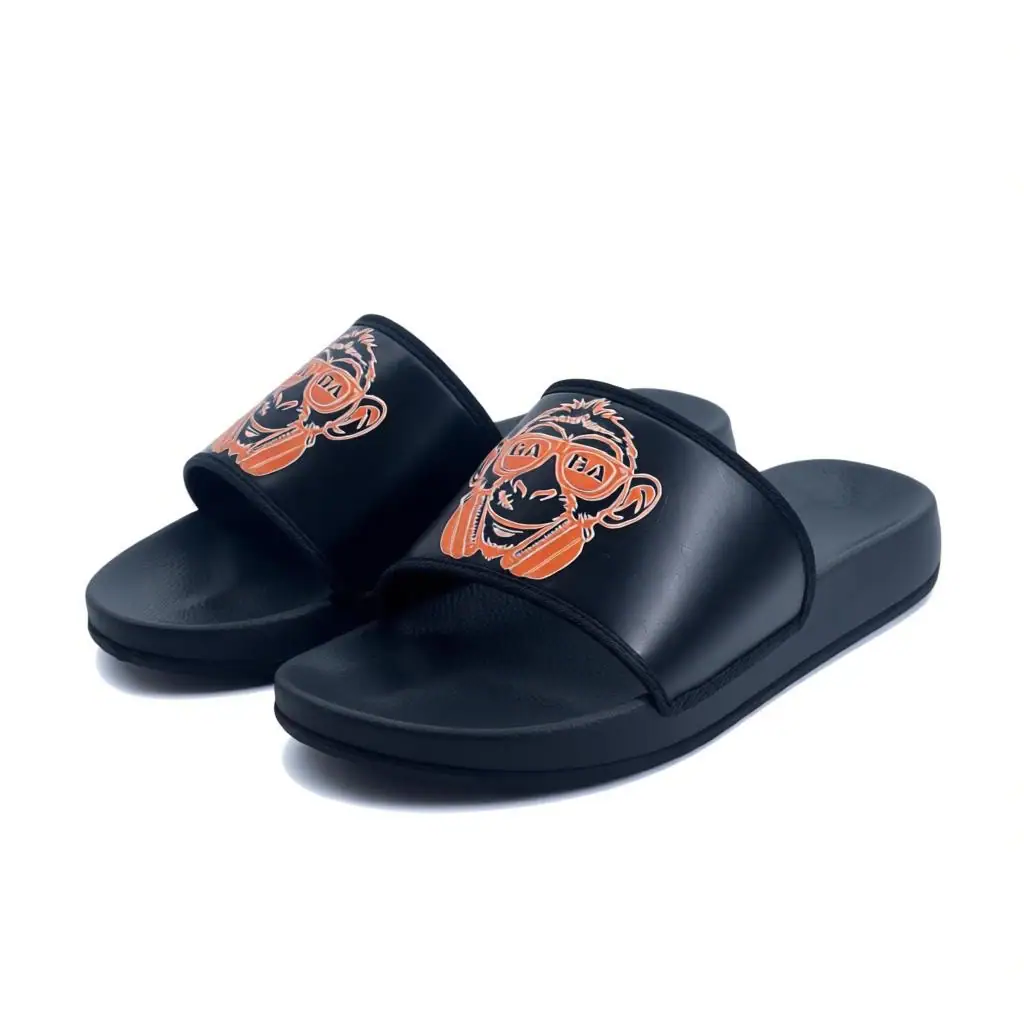 Black slide sandals with orange lion logo, perfect for casual wear and summer style.