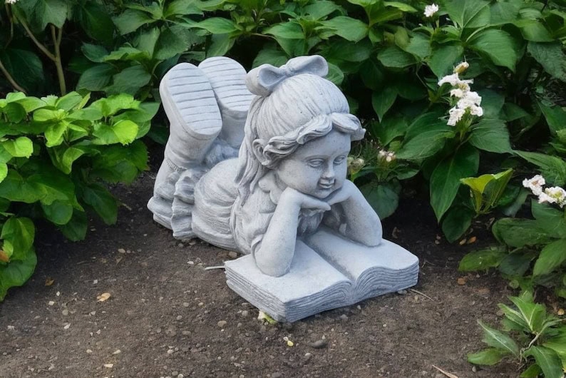 Concrete girl reading book garden statue