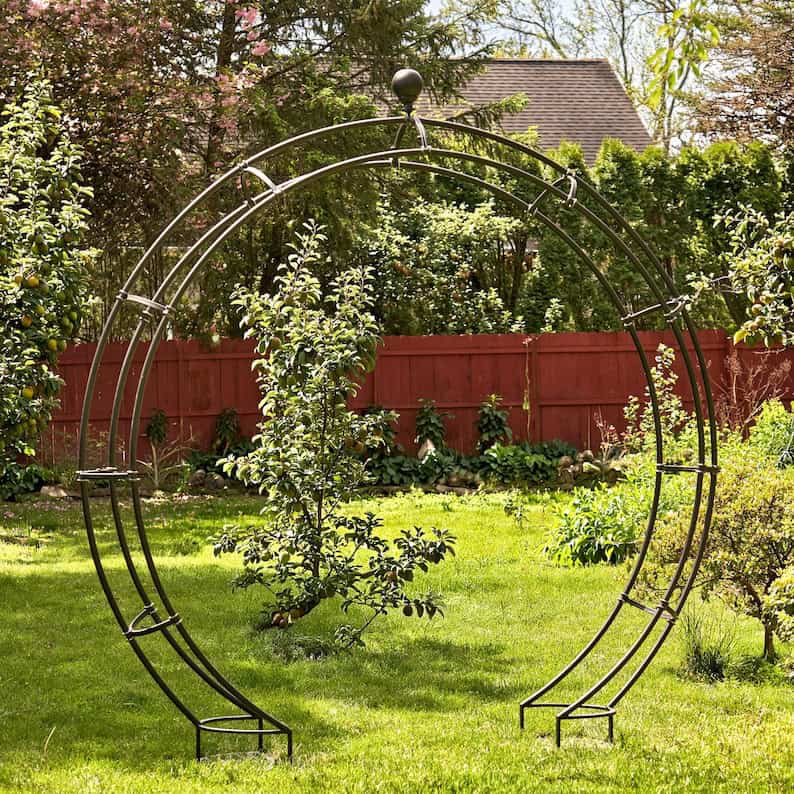 iron  moon gate trellis with plant stands