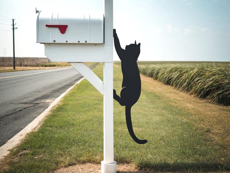 black metal cat sculpture climbing mailbox