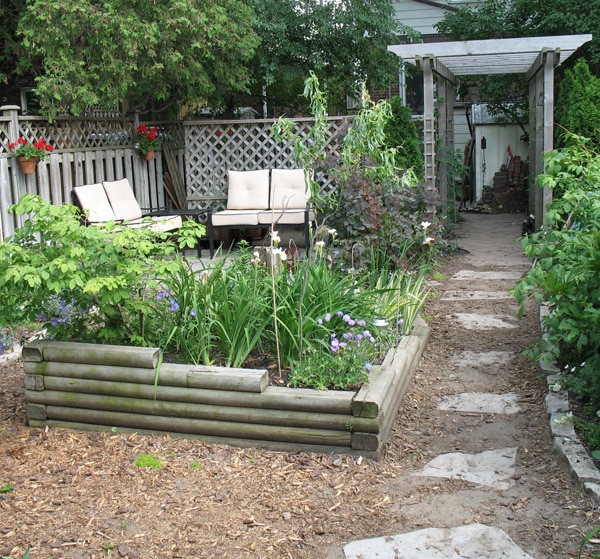 flagstone patio and pergola in small city garden