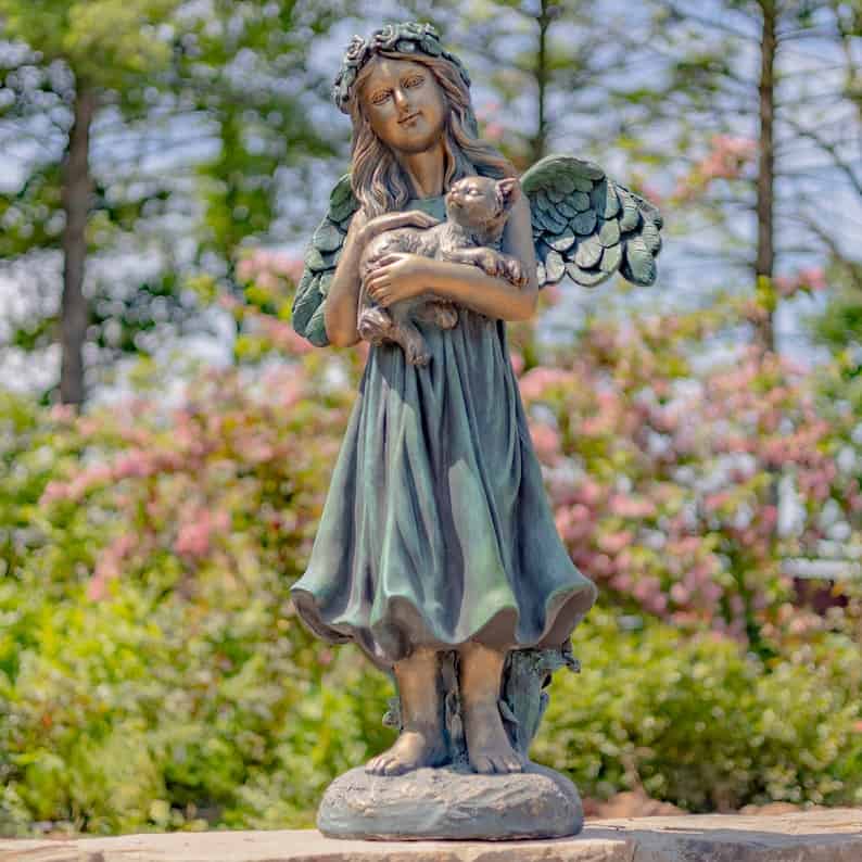 angel holding a cat statue