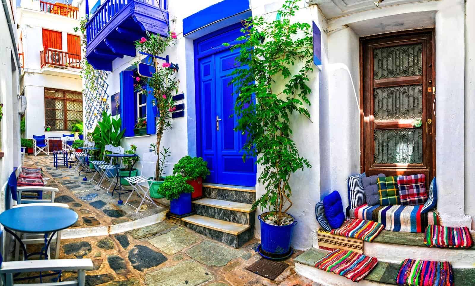 Traditional narrow streets with cute cafe bars in Greece. Skopel
