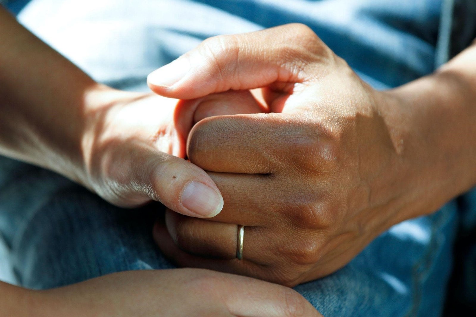 A Picture Of Two People Holding Hands In A Hospital Waiting Room
