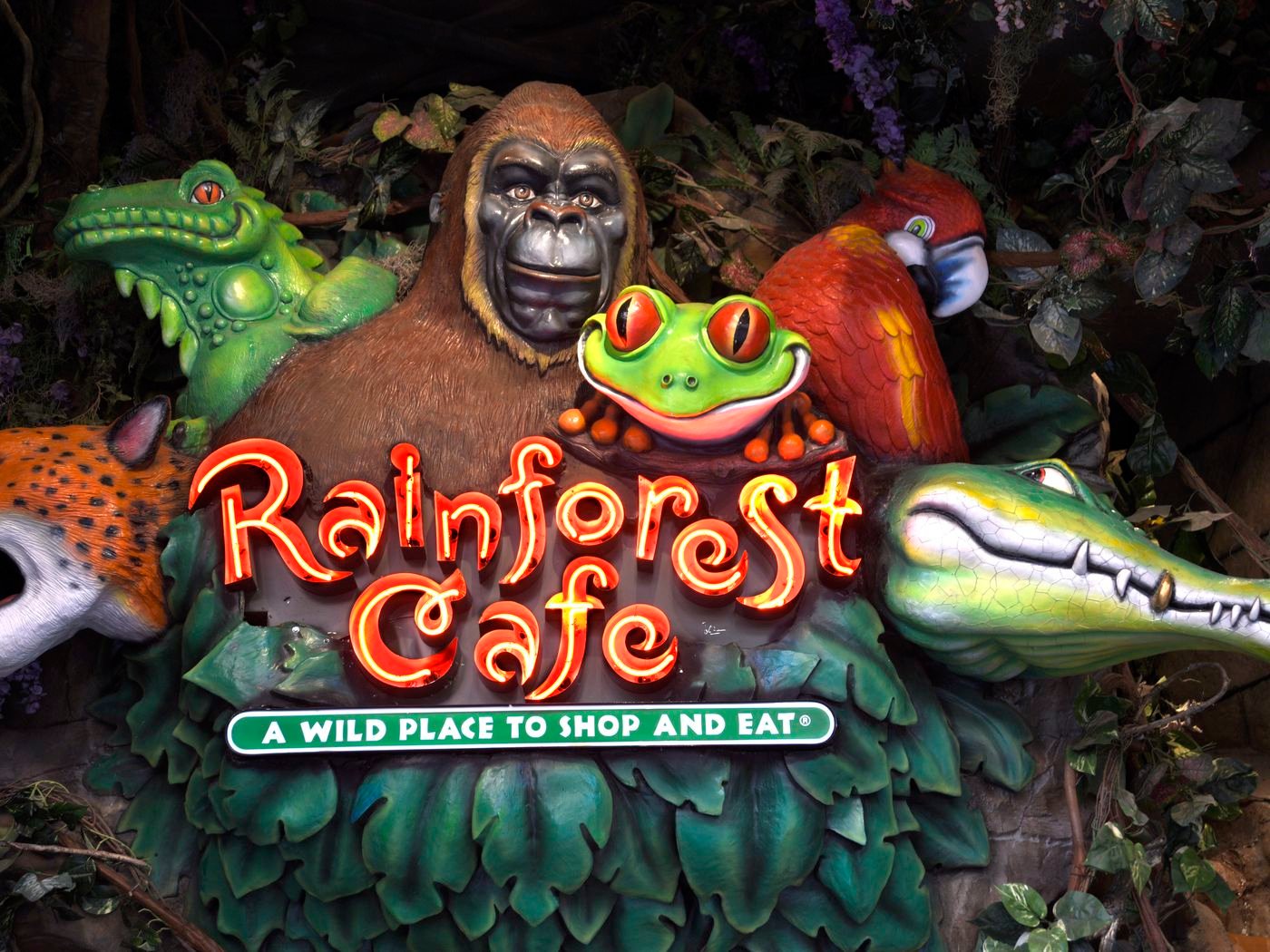 A Vibrant Rainforest-Themed Restaurant With Animatronic Animals, Surrounded By Lush Greenery.