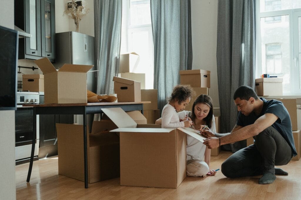 The Dos And Don'Ts Of The Moving-In Process 2 Family Of Three Unpacking After Moving Into Their New Place