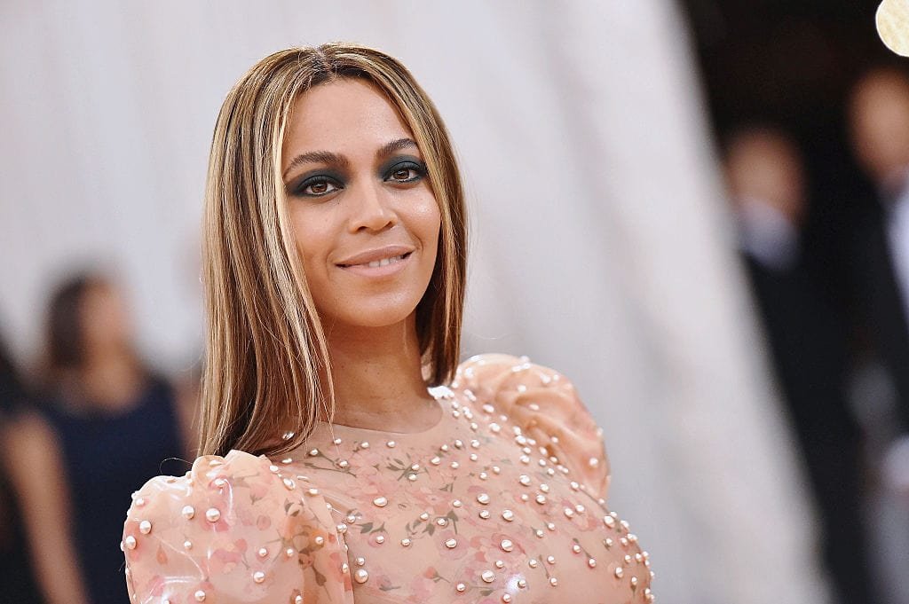 Beyoncé Performing On Stage, Representing Her Iconic Career And Success.