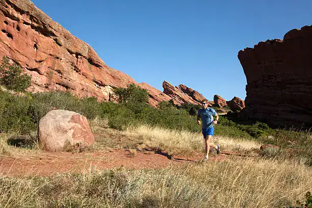 Runner training on a Colorado trail before a cold plunge recovery session at ROK SPAS Denver