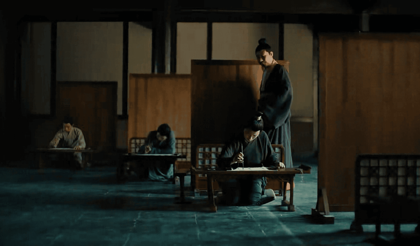 Depiction of the ancient Chinese national exam, with candidates seated and writing in a traditional examination hall.