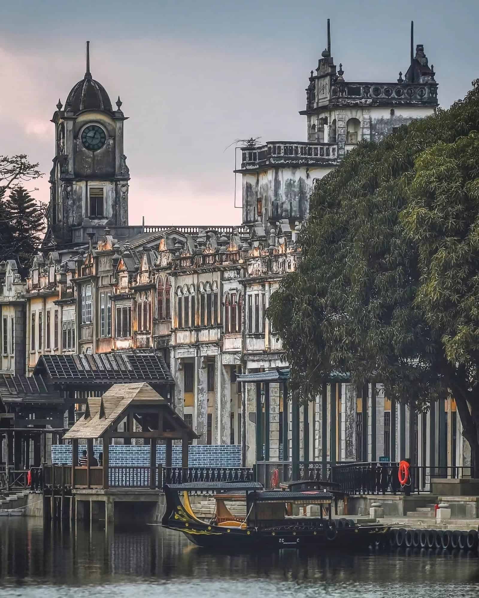 Historic architecture of Chikan Town, Guangdong, China, with vintage buildings and traditional Chinese gondolas along the river.