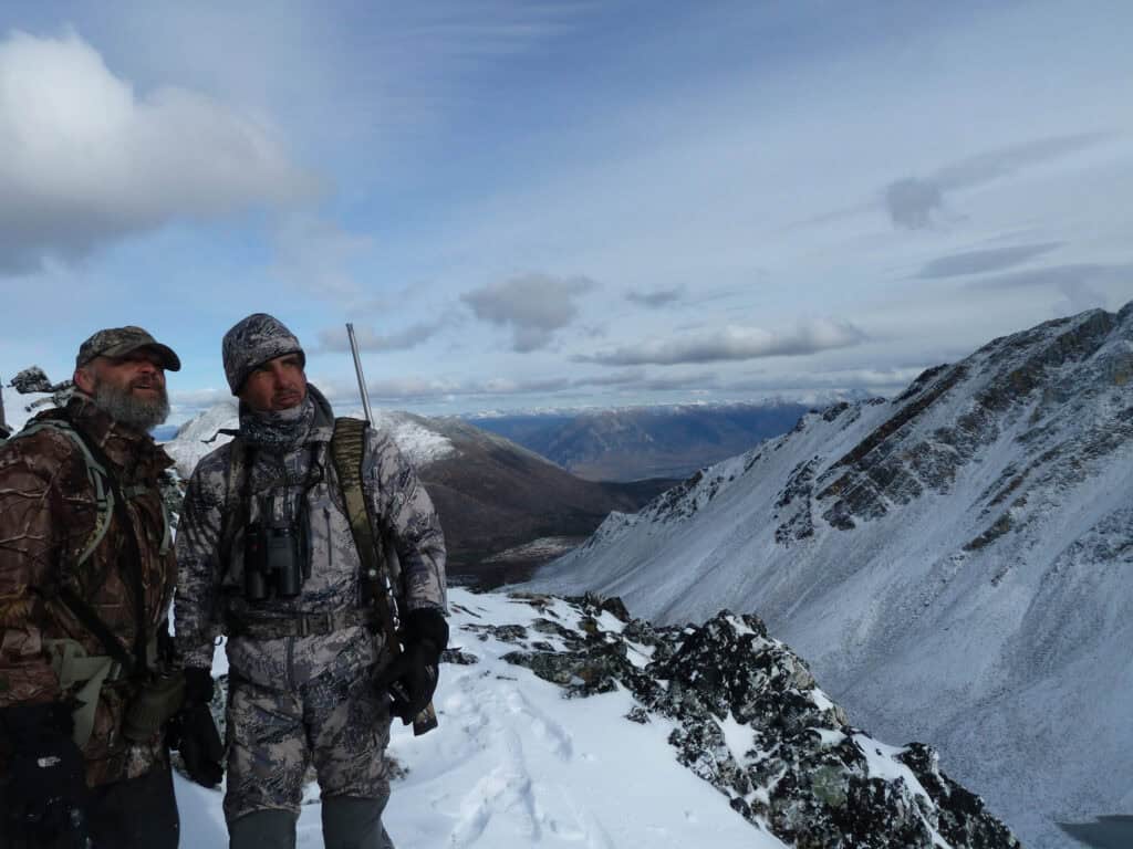 Experienced hunters enjoying the snowy mountain landscape.