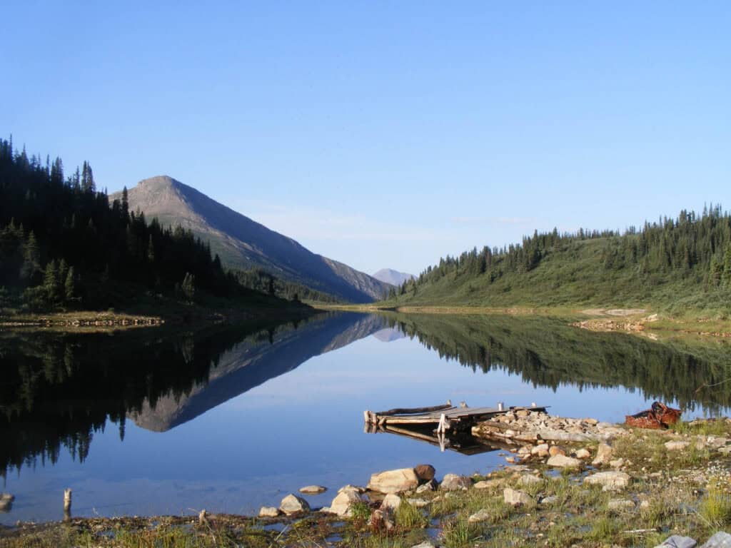 Beautiful mountain lake view ideal for outdoor adventures and fishing trips.